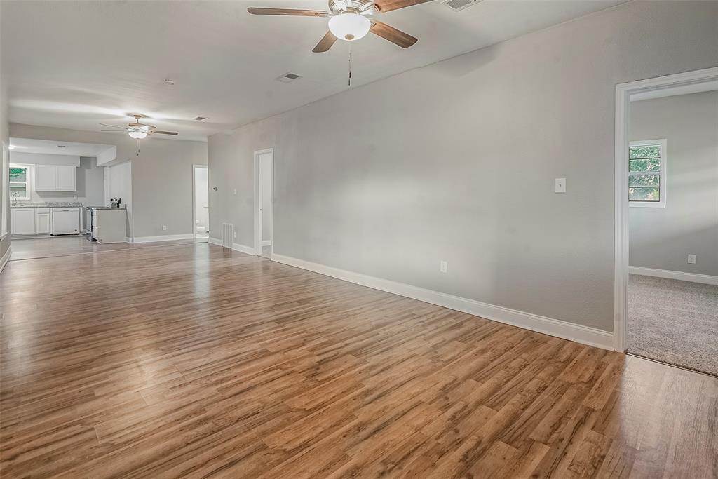 306 North Front Street Savoy, TX 75479 - Photo 4 of 19 wooden floor in an empty room with a window