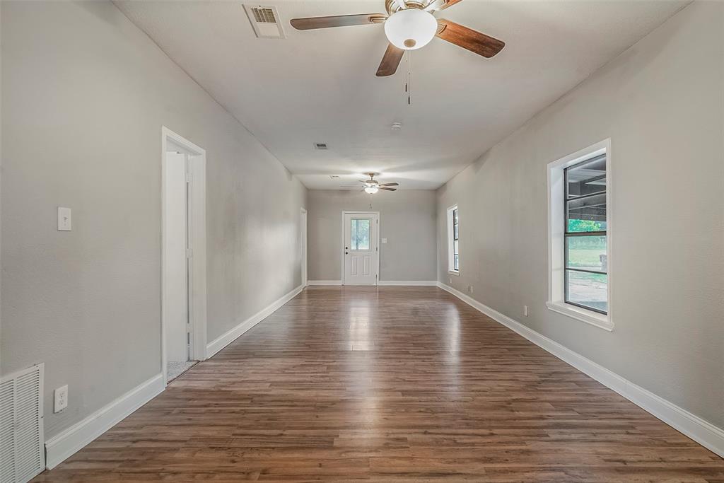 306 North Front Street Savoy, TX 75479 - Photo 5 of 19 wooden floor in an empty room with a window