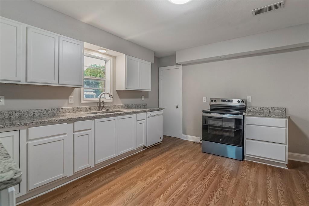 306 North Front Street Savoy, TX 75479 - Photo 9 of 27 a kitchen with a stove a sink and a window