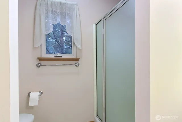 a bathroom with a shower and vanity