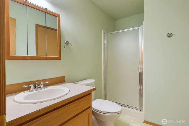 a bathroom with a sink toilet and mirror