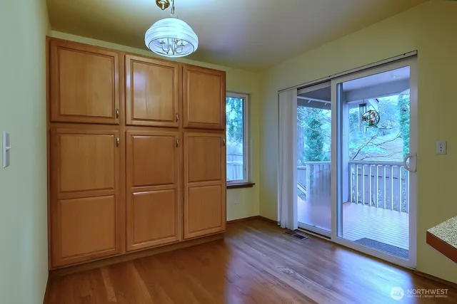 a view of a room with wooden floor
