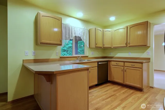 a kitchen with stainless steel appliances granite countertop a sink and a stove