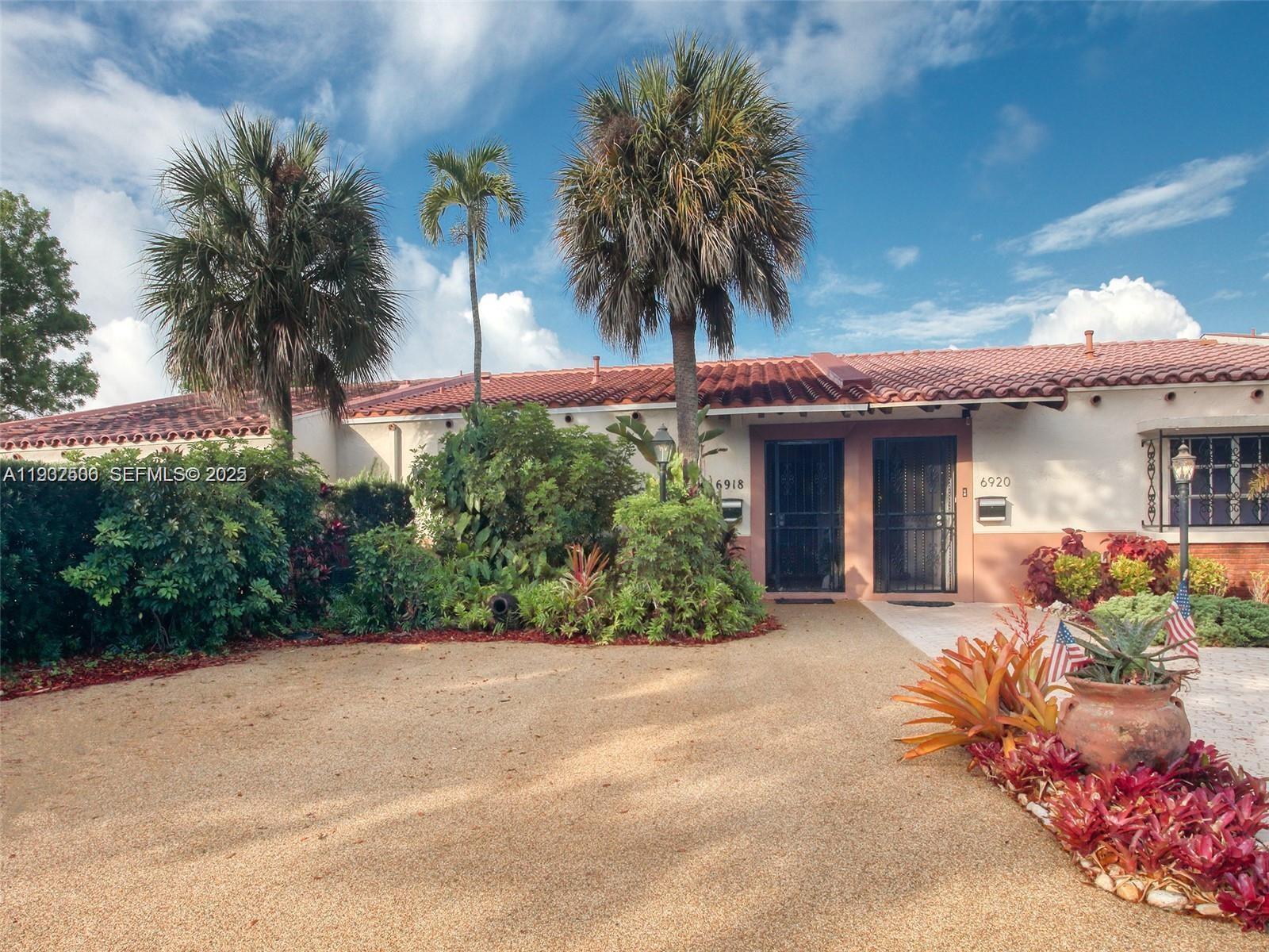 6918 Holly Road Miami Lakes, FL 33014 - Photo 4 of 10 a front view of a house with a garden