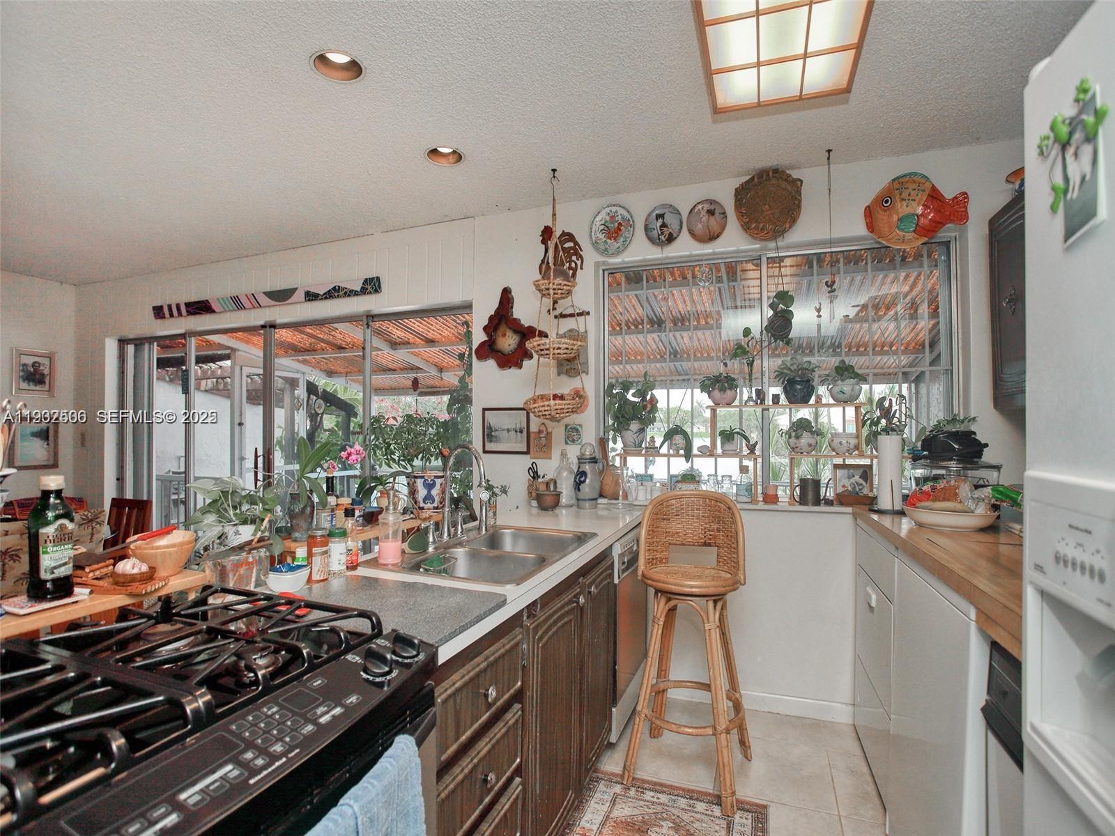 6918 Holly Road Miami Lakes, FL 33014 - Photo 5 of 10 a kitchen with a stove and a table