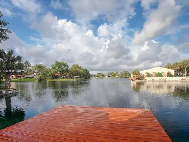 a view of a lake with houses in the back