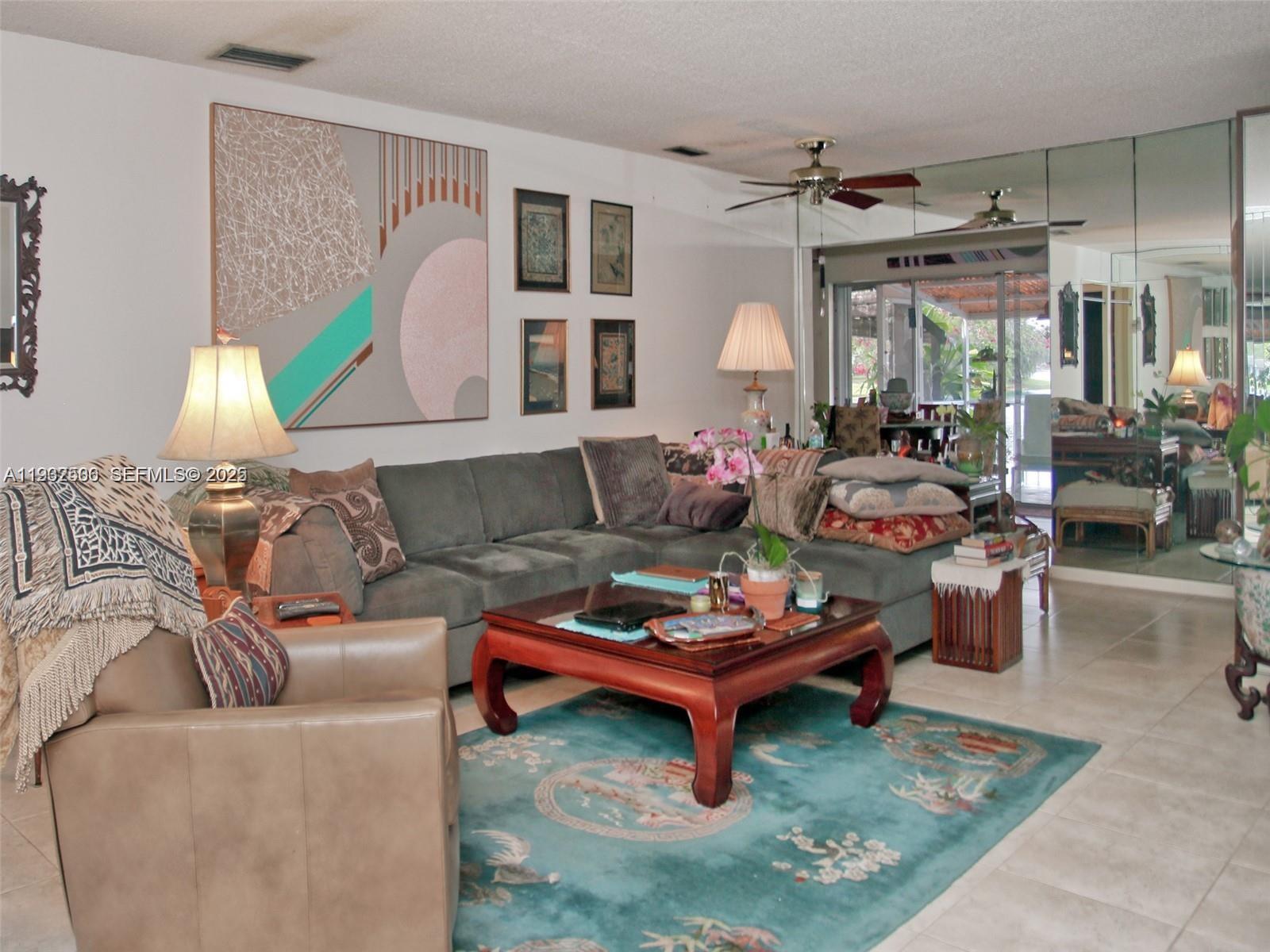 6918 Holly Road Miami Lakes, FL 33014 - Photo 8 of 10 a living room with furniture and a large window