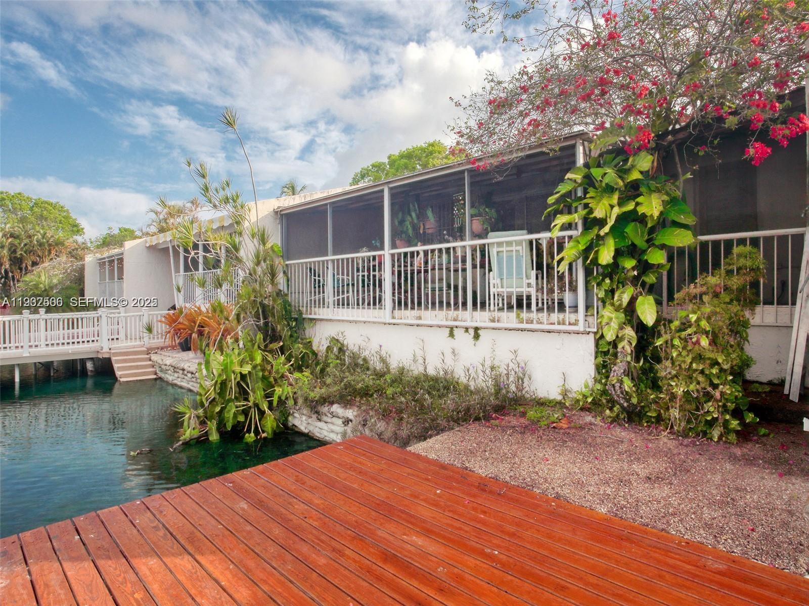 6918 Holly Road Miami Lakes, FL 33014 - Photo 9 of 10 a house with garden in front of it