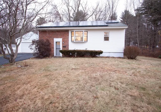 a view of a house with a yard and garage