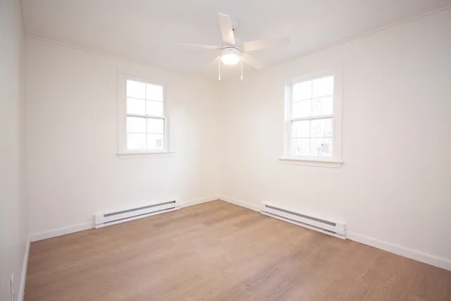 an empty room with windows and closet