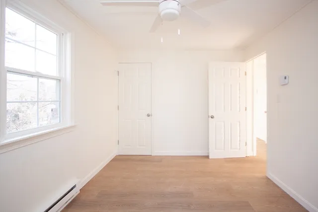 an empty room with windows and closet