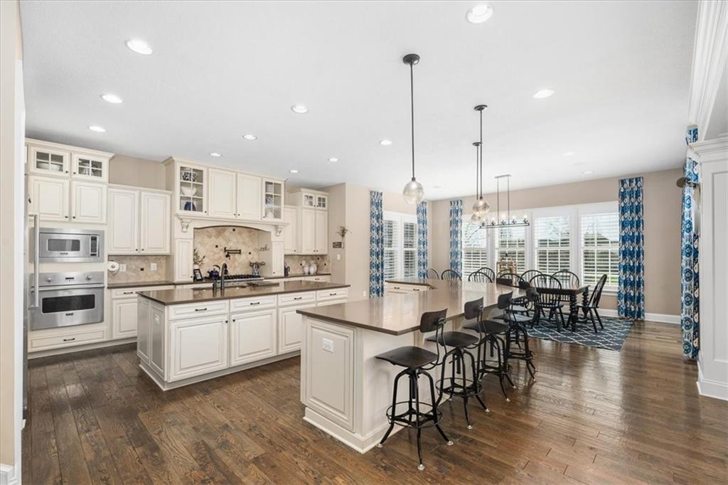 102 Minnock Drive Mars, PA 16046 - Photo 12 of 50 a kitchen with stainless steel appliances a stove a sink a center island and a wooden floor
