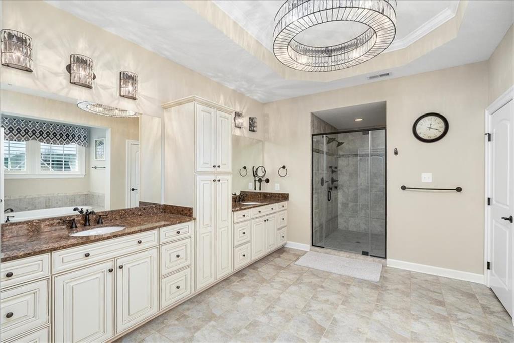 102 Minnock Drive Mars, PA 16046 - Photo 28 of 50 a bathroom with a granite countertop sink a toilet a mirror and shower