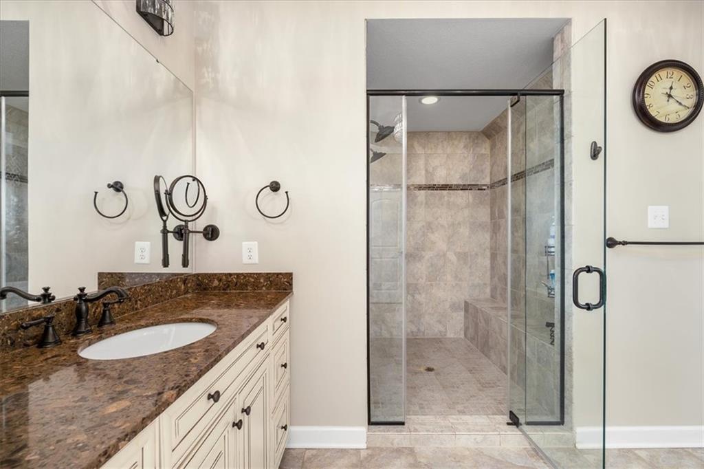 102 Minnock Drive Mars, PA 16046 - Photo 29 of 50 a bathroom with a granite countertop sink a mirror and shower