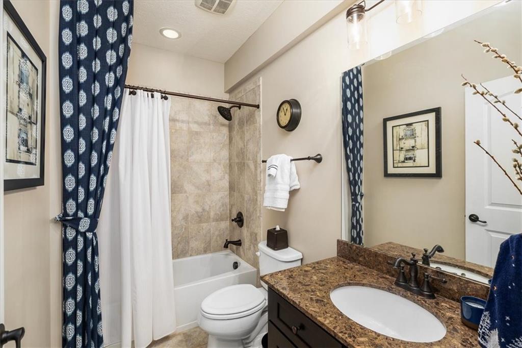 102 Minnock Drive Mars, PA 16046 - Photo 43 of 50 a bathroom with a granite countertop sink toilet a shower and a mirror