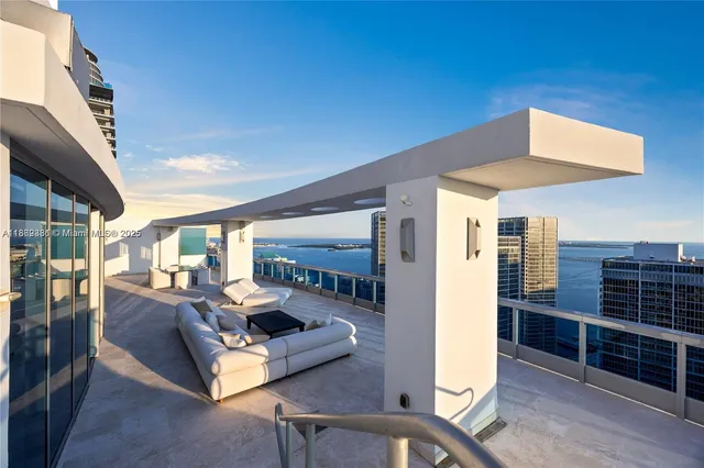 a living room with furniture and large windows