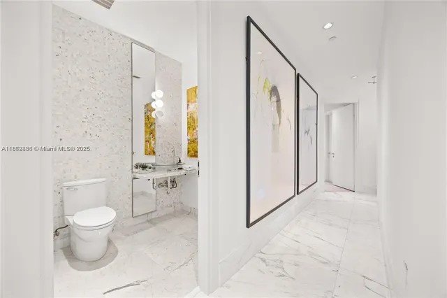 a bathroom with a granite countertop sink a toilet and shower