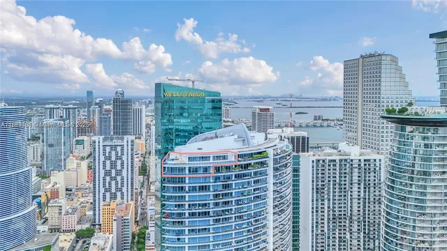 a living room with furniture and potted plants