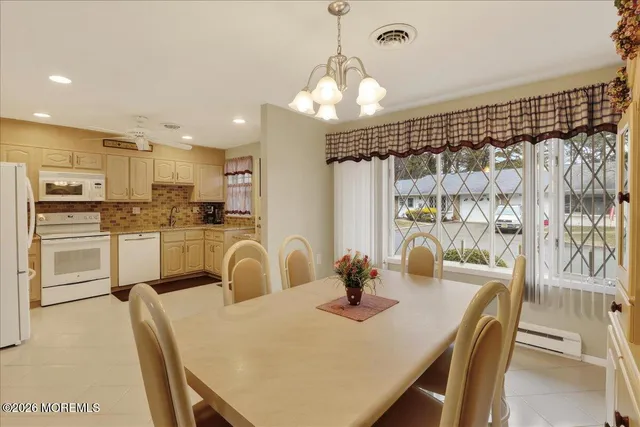 a kitchen with granite countertop a table and chairs