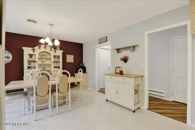 a dining room with furniture and window