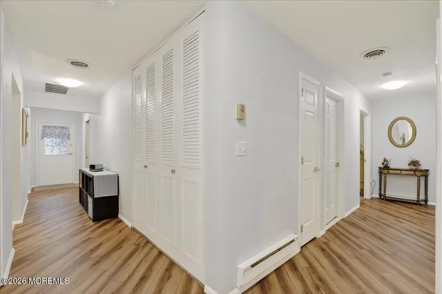 a view of a room with wooden floor and furniture