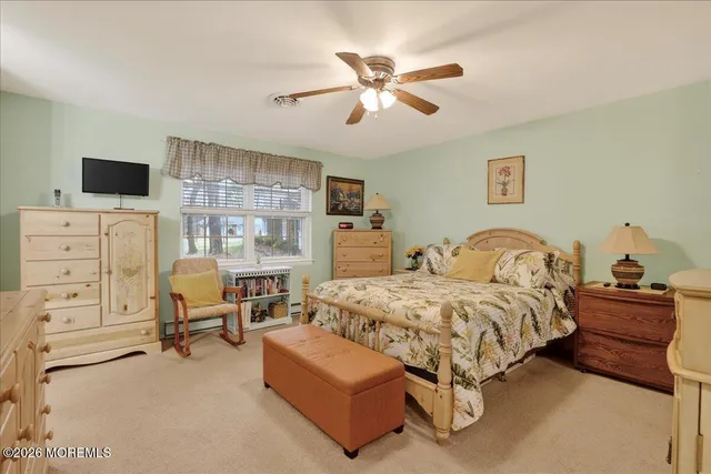 a bedroom with furniture and white furniture