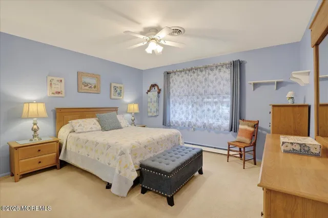 a bedroom with a bed dresser and a window