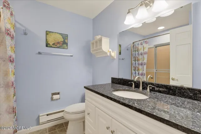 a bathroom with a shower and a toilet