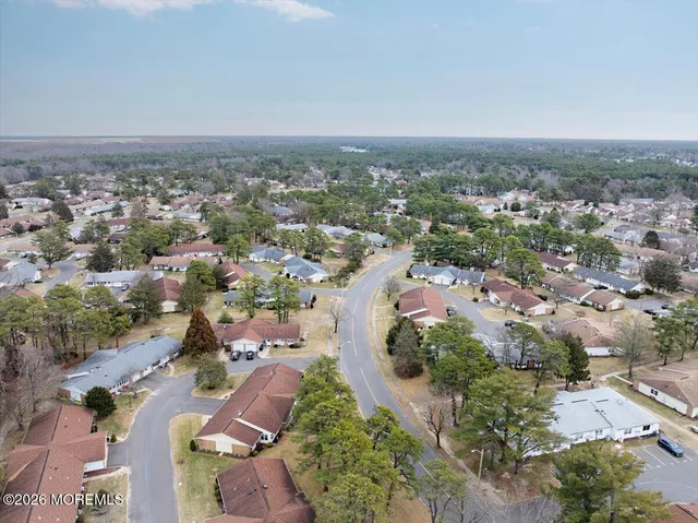an aerial view of a backyard and swimming pool