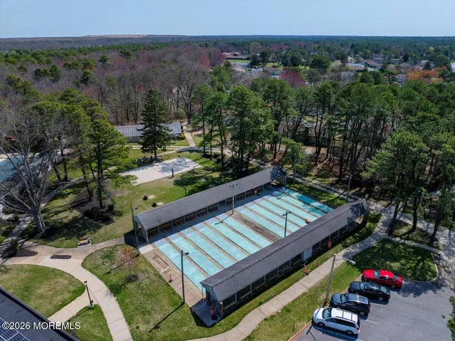 a view of a garden with large trees