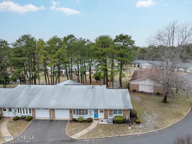 an aerial view of a house with garden space and sitting area