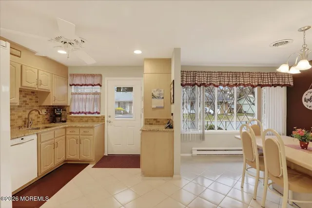 a kitchen with a refrigerator and a stove top oven