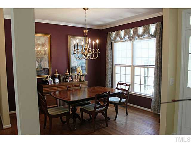 Formal dining area with glowing hardwood floors