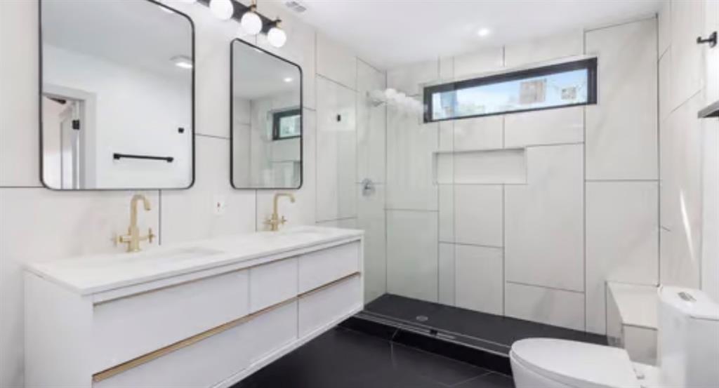 4927 Linnet Lane Dallas, TX 75209 - Photo 8 of 17 a bathroom with a sink double vanity and a toilet