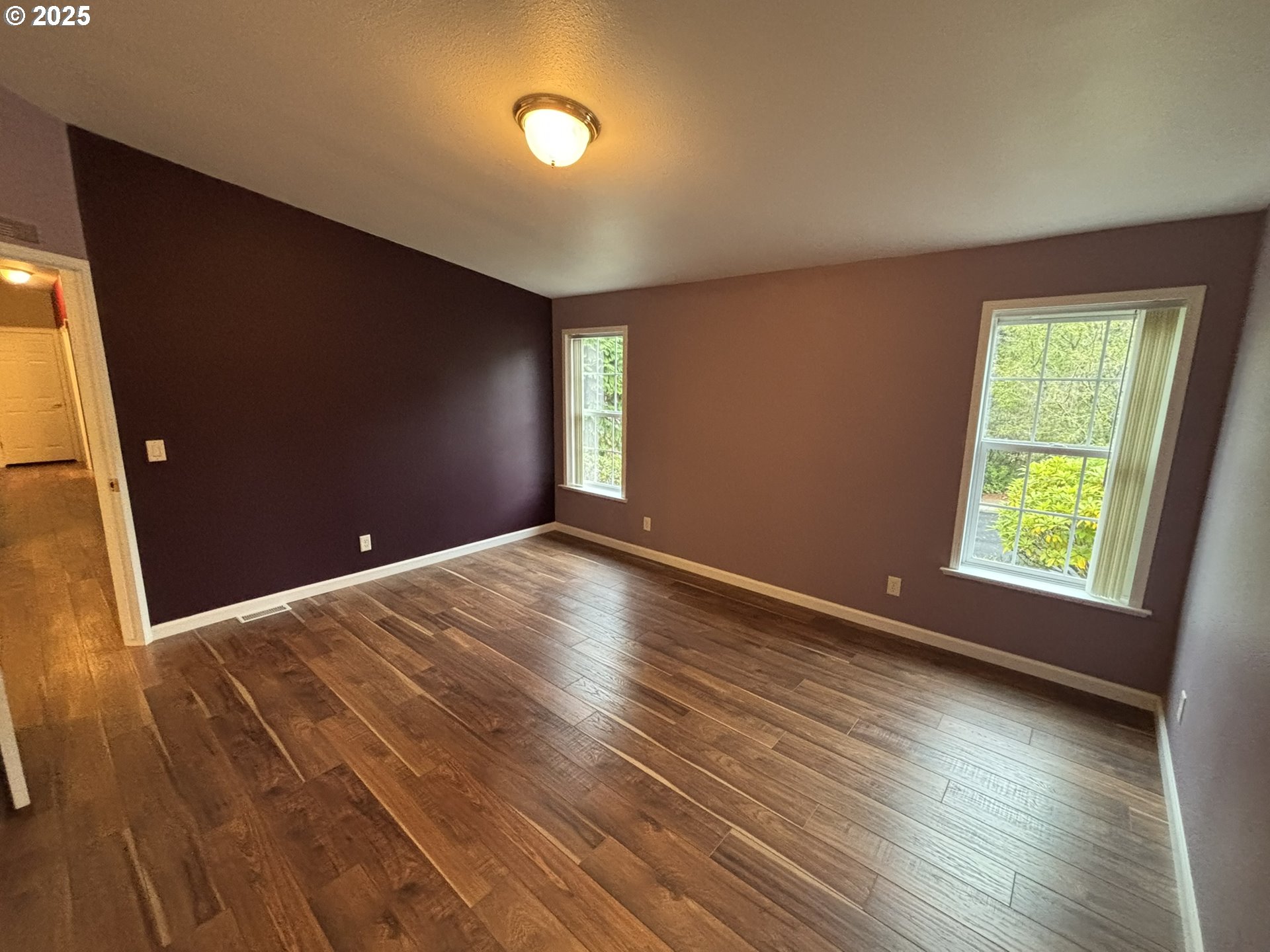 325 Jonathan Lane Florence, OR 97439 - Photo 16 of 37 an empty room with wooden floor and windows