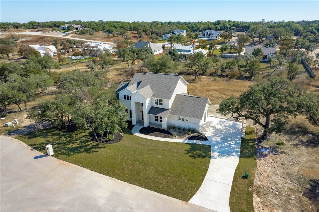 an aerial view of a house with a yard swimming pool and outdoor seating