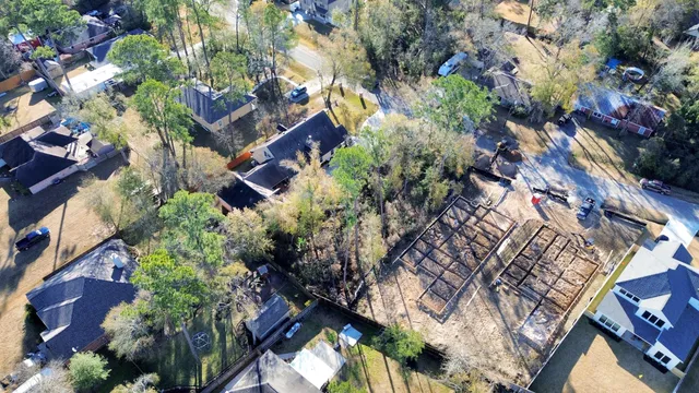 an aerial view of a house with a yard and garden