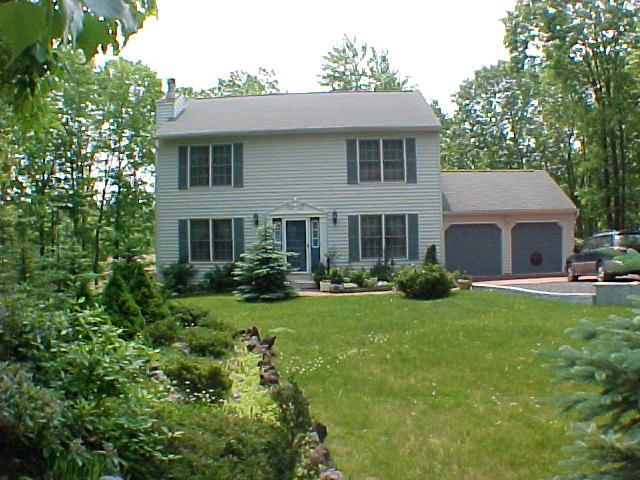 29 Holly Forest Road Mount Pocono, PA 18344 - Photo 1 of 14 a front view of a house with garden and porch