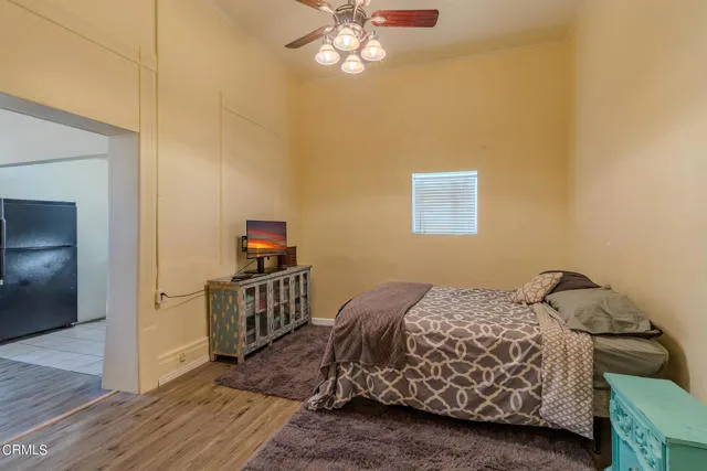 813 West Broadway Street Needles, CA 92363 - Photo 6 of 27 a bedroom with a bed and a chandelier