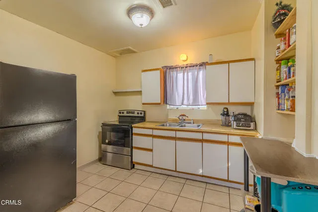 813 West Broadway Street Needles, CA 92363 - Photo 8 of 27 a kitchen with a sink appliances and cabinets
