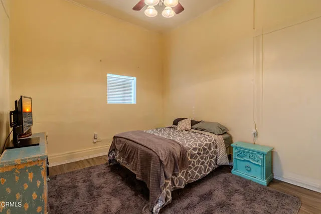 813 West Broadway Street Needles, CA 92363 - Photo 10 of 27 a bedroom with a bed and a chandelier
