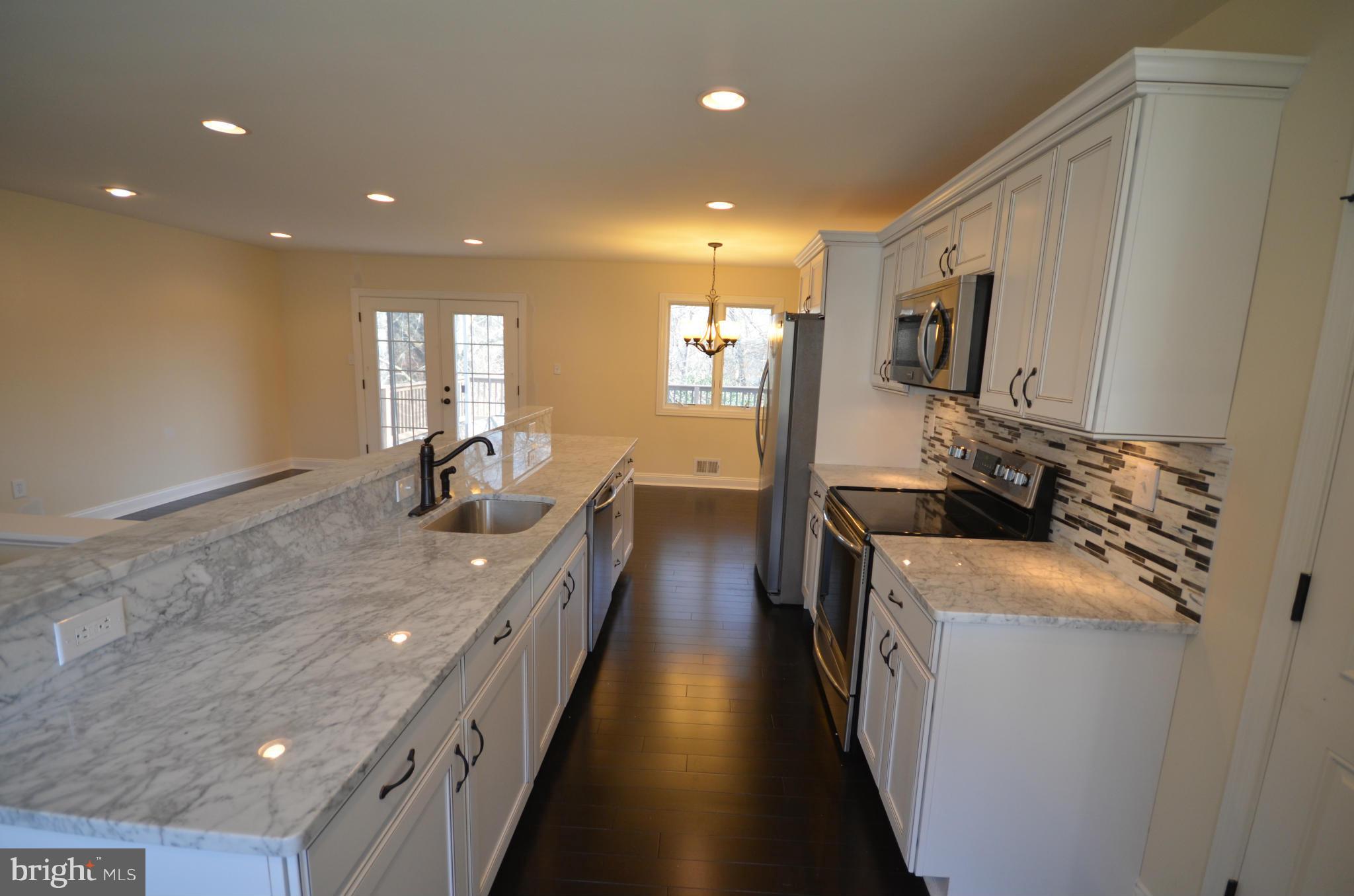 6405 Darwin Road Laurel, MD 20707 - Photo 5 of 20 a kitchen with stainless steel appliances a sink stove and refrigerator