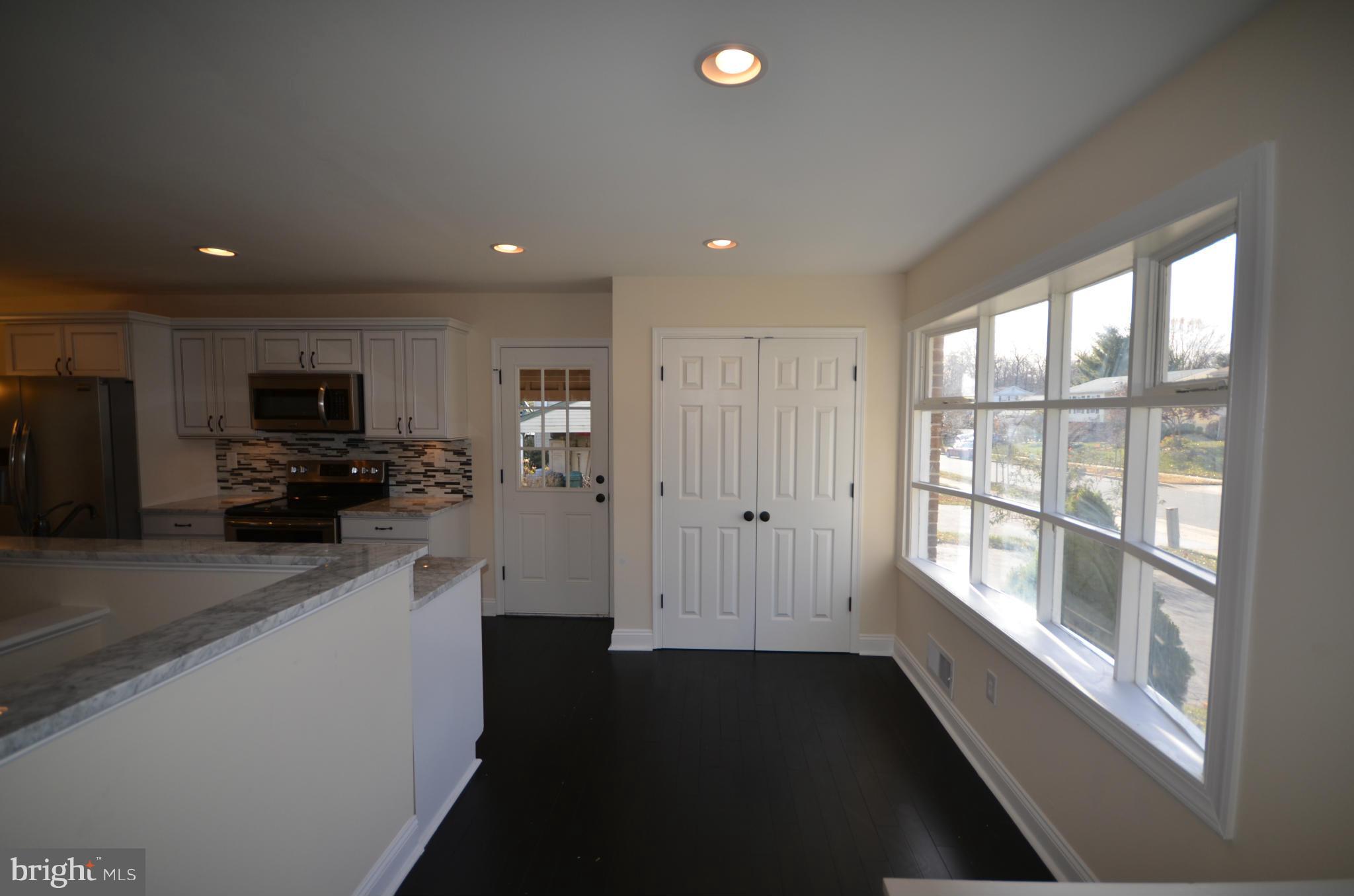 6405 Darwin Road Laurel, MD 20707 - Photo 6 of 20 a kitchen with stainless steel appliances a refrigerator and a sink