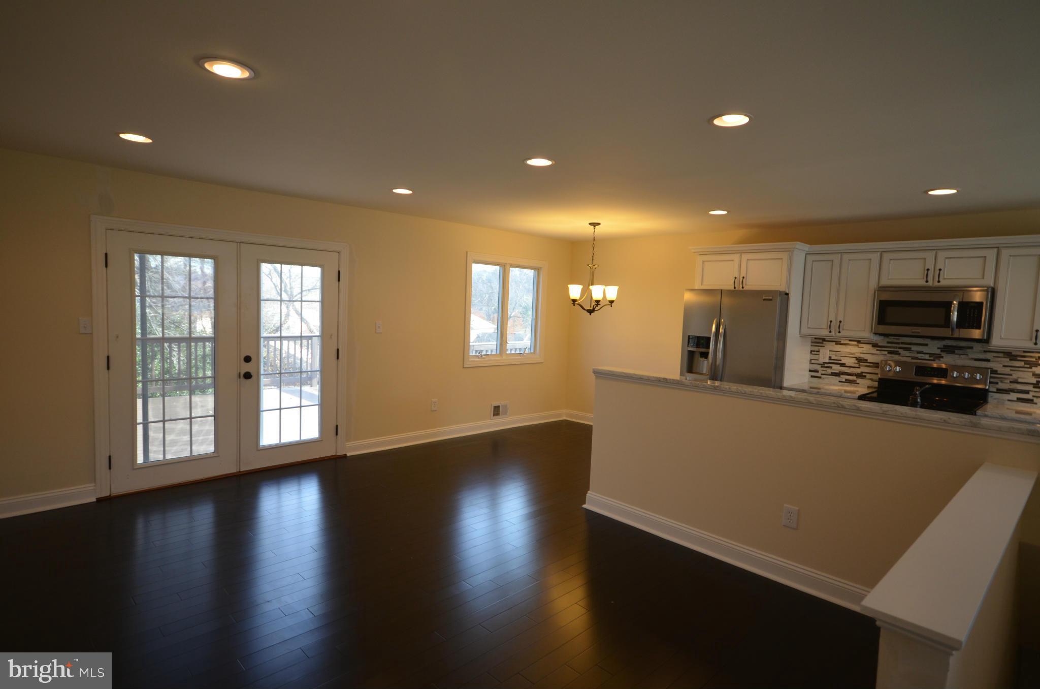 6405 Darwin Road Laurel, MD 20707 - Photo 7 of 20 a view of a kitchen with a sink and a stove top oven with wooden floor