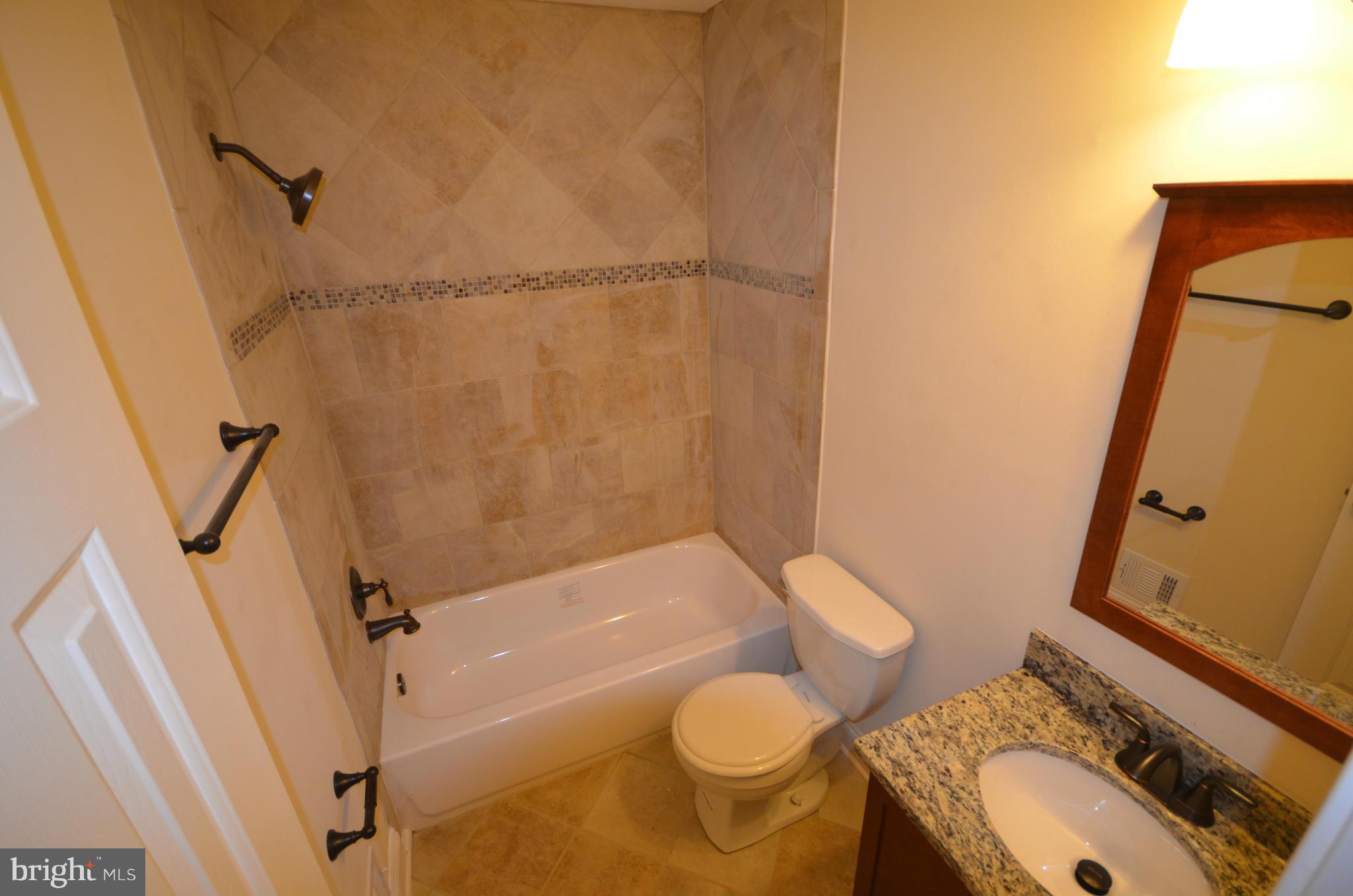 6405 Darwin Road Laurel, MD 20707 - Photo 10 of 20 a bathroom with a sink toilet and shower
