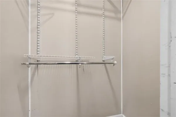 a view of a room with wooden floor and windows