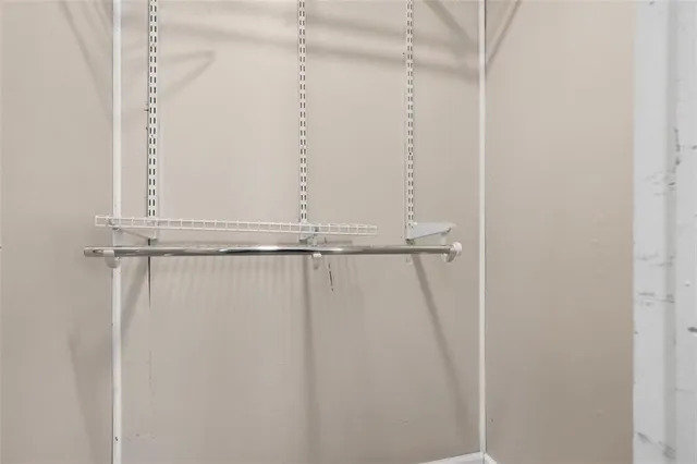 a view of a room with wooden floor and windows