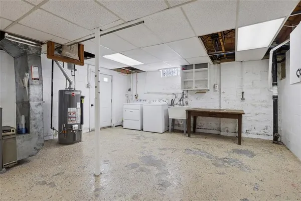 a view of a storage & utility room with two washing machine