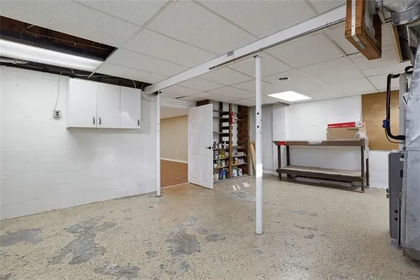 an empty room with closet and windows