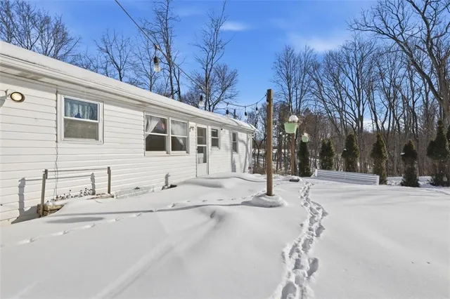 a white house with a tree in front of it